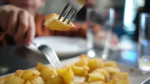 Spanish tapas seafood fish potatoes tortilla hands children family eating Stock Footage 235608491