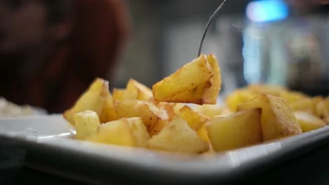 Spanish tapas seafood fish potatoes tortilla hands children family eating Stock Footage 235608527
