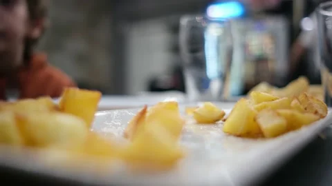 Spanish tapas seafood fish potatoes tortilla hands children family eating Stock Footage 235608529