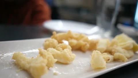 Spanish tapas seafood fish potatoes tortilla hands children family eating Stock Footage 235608566