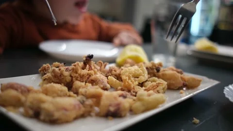 Spanish tapas seafood fish potatoes tortilla hands children family eating Stock Footage 235608568