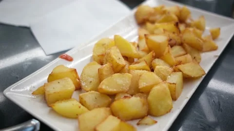 Spanish tapas seafood fish potatoes tortilla hands children family eating Stock Footage 235608580