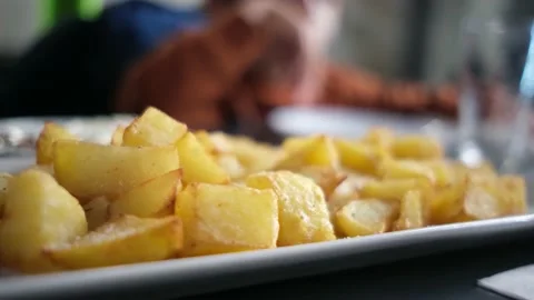 Spanish tapas seafood fish potatoes tortilla hands children family eating Stock Footage 235608593