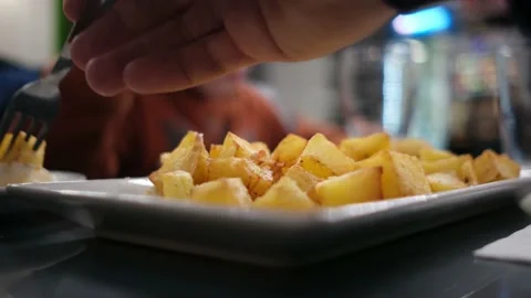 Spanish tapas seafood fish potatoes tortilla hands children family eating Stock Footage 235608610
