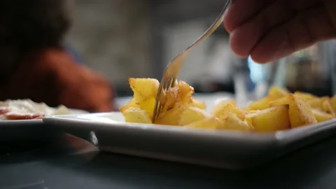 Spanish tapas seafood fish potatoes tortilla hands children family eating Stock Footage 235608627