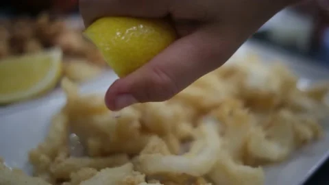 Spanish tapas seafood fish potatoes tortilla hands children family eating Stock Footage 235608636