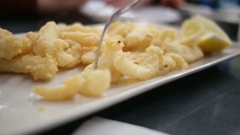 Spanish tapas seafood fish potatoes tortilla hands children family eating Stock Footage 235608648