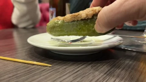 Spanish Tapas: Tuna-Filled Pickle Served on a Small White Plate in a Bar Stock Footage 331562578