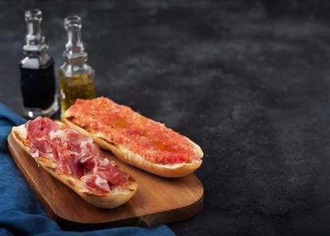 Spanish tomato and ham toast, traditional breakfast or lunch Stock Photos