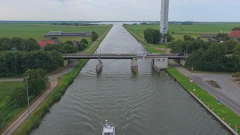 Spannenburg data tower overlooking boat on dutch canal Stockbeeldmateriaal 341876435