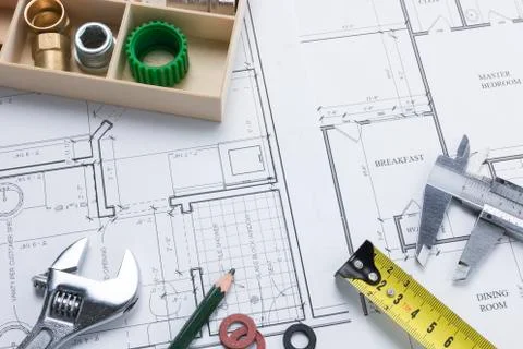 Spanner, Pencil, Measuring Tools and Plumbing Parts on Building Plan Stock Photos