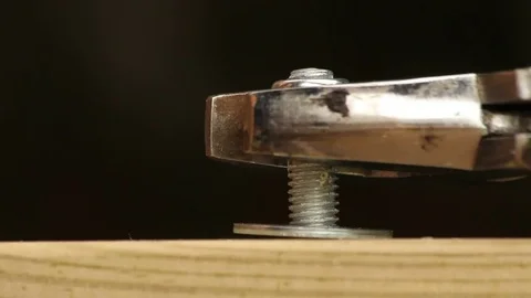 Spanner twisting a nut onto a bolt. Macro shot Stock Footage 72558543