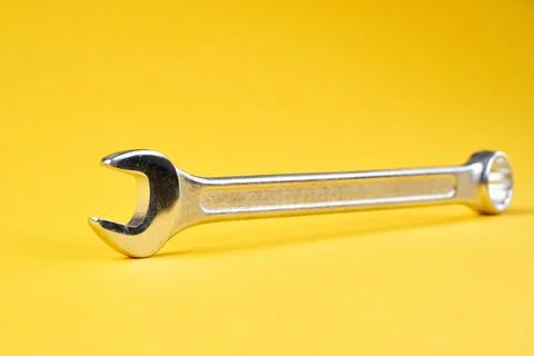 Spanner on yellow background close up. Stock Photos