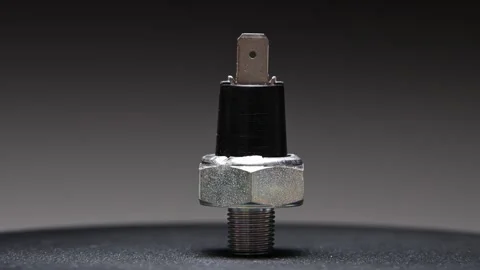 Spare part. New engine oil temperature sensor. Rotating new part against a 스톡 동영상 328909938