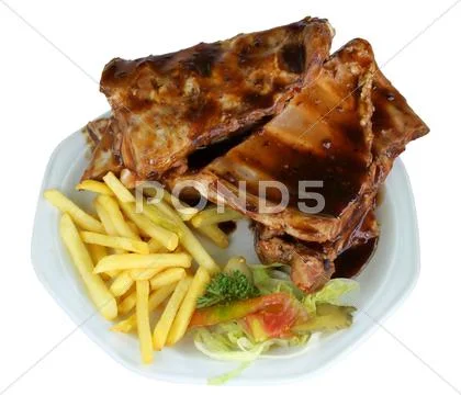 Spareribs and fries on white plate Stock Photos