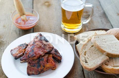 Spareribs on grill with hot marinade, czech beer Stock Photos