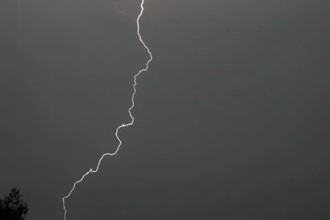 A spark discharge between a cloud and the ground. Stock Photos