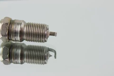 Spark plug on mirror Stock Photos