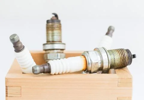 Spark plug in wood box Stock Photos