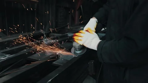Spark rain from the grinder. A locksmith cleans a metal surface  Stock Footage 154519174