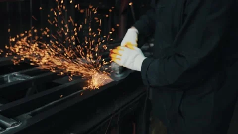 Spark rain from the grinder. A locksmith cleans a metal surface that demonstrate Stock Footage 154519183