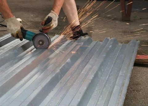 Sparking grinder in the process of sawing sheet iron Stock Photos