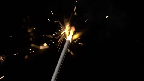 Sparking light from a firework during a celebration at night in the backyard Stock Footage 322791055