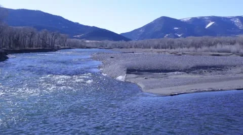 Sparking River Against Mountain Backdrop Stock Footage 21236469