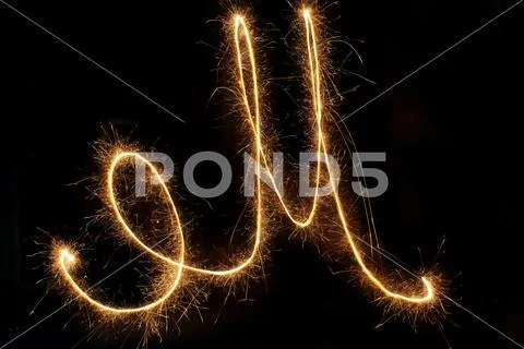 Sparkle firework writing font on black background Stock Photos
