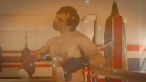 Sparkle overlay appearing, boxer leaning on ropes slowly straightening and Stockbeeldmateriaal 333078623