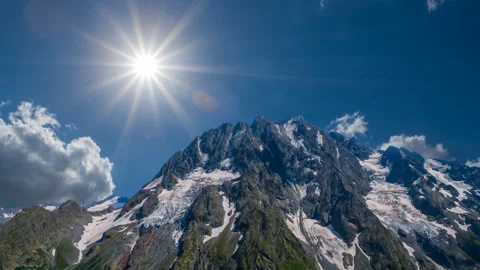 Sparkle sun above a mount top Stock Footage 333276467