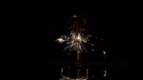 Sparkler Behind LED Light Bulb - Lower Half in Slow Motion 库存影片 99122089