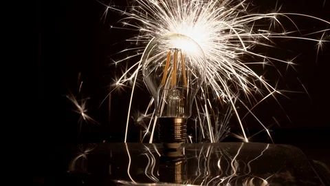 Sparkler Behind LED Light Bulb With Long Fast Sparks and Reflection 库存影片 99122116