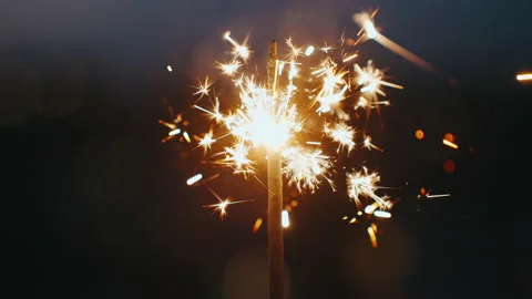 Sparkler Bengali fire bright burning wand of against of bokeh of evening city Stock-Footage 232373523