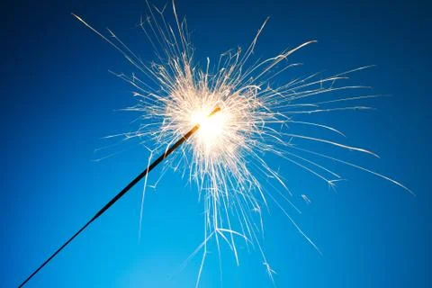 Sparkler on blue background Stock Photos