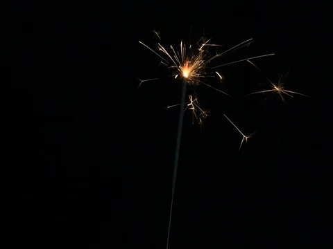 Sparkler burning against a black background Stock Footage 74171941