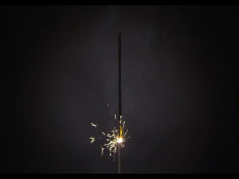 Sparkler burning on a black background, m/s, slow motion. Fading Stock Footage 74288431