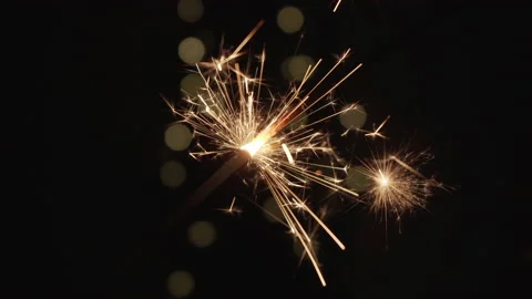 Sparkler burning out in the darkness with bokeh at background Stock Footage 146702318
