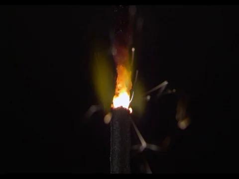 Sparkler burning,macroshot, camera moving along, slow motion, Sparks are flying Stock Footage 74315162