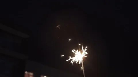 Sparkler burns at night. Sparks fly. 库存影片 123745795