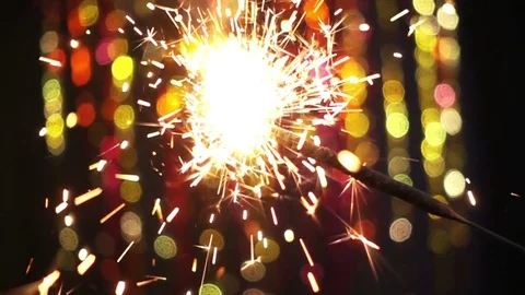 Sparkler On Color Bokeh Background Stock Footage 71482026