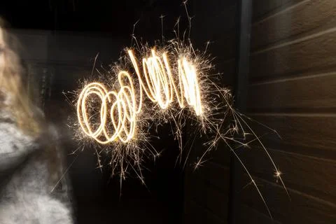 Sparkler creating light painting pattern in darkness 写真素材