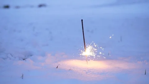 Sparkler firework stick in snow, burn almost to end. Bright sparks fly around 스톡 동영상 83446608