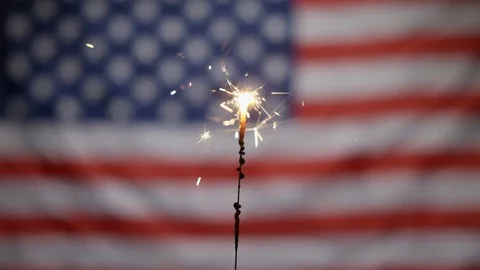 Sparkler going out in front of american flag Stock Footage 90494703