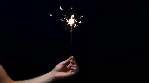 Sparkler in Hand on a Black Background Stock Footage 228244831