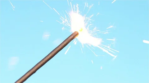 Sparkler isolated on blue background Stock Footage