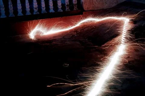 Sparkler Light Trail Motion on the Ground at Night Stock Photos