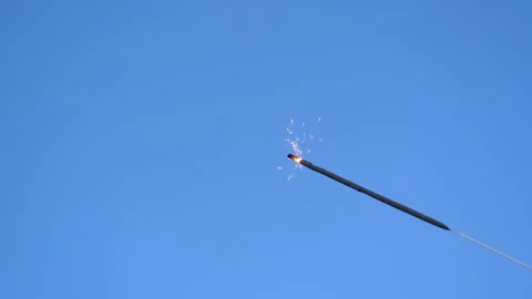 Sparkler in the lower corner against blue background Vídeo Stock 130759730