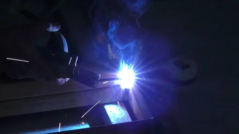 The sparklers and the flash of light when welding the joints of iron Stock Footage 112854688