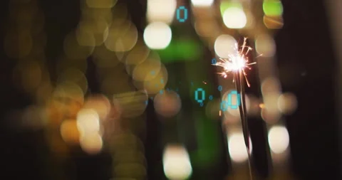 Sparklers with binary code animation over blurred festive lights background Stock Footage 306274347